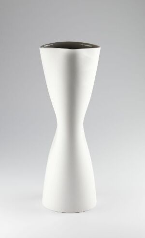  "Pinched Pitcher," a porcelain tableware design by Margit Seland, featuring a white, minimalist, sculpturally pinched form with a contrasting dark rim, set against a gradient gray background.