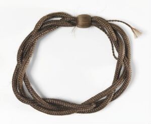  A coiled or looped brown braided rope or cord with a securing fastener or bead, set against a light off-white background.