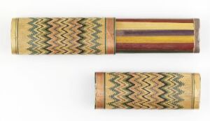 
 Two cylindrical objects with intricate patterns, the top one featuring a chevron design in green, yellow, and red, flanking a central band with maroon, purple, and reddish-brown stripes, and the bottom one displaying the same chevron design, oriented differently.