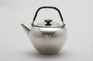  A modern stainless steel teapot with a rounded body, reflective surface, and a black handle and lid knob, set against a white background.