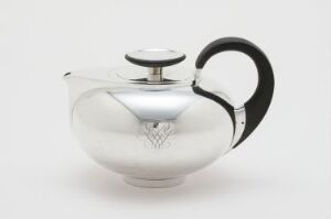  A sterling silver teapot designed by David-Andersen with a curved, bulbous body, contrasting black handle and knob, featuring a reflective surface and minimalist design set against a white background.