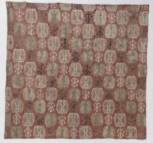  Antique square textile with a repeating pattern of eight-petaled flowers or rosettes in shades of ivory and sage green on a deep rust reddish-brown background. The overall appearance is of a quilt or mosaic made from a grid of interconnecting bordered designs.