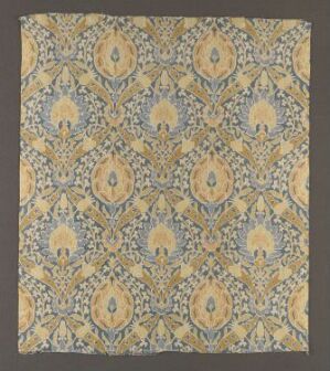  A square piece of fabric or artwork with a symmetrical, detailed pattern featuring diamond shapes with floral designs in shades of golden yellow, turquoise blue, and soft peach, interconnected by leafy vines and scroll-like details on an off-white or light grey background. Artist and title unknown.