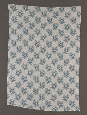  A rectangular piece of fabric with a repeated floral pattern in various shades of blue on an off-white background, suggesting a vintage or traditional textile design.