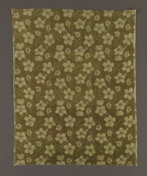  A patterned fabric with a repeating print of white flowers on an olive green background, giving off a vintage, natural aesthetic.