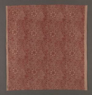  "Marigold" by William Morris, a warm brick red cotton fabric with a machine-woven two-shaft twill binding and a repetitive, intricately printed pattern of stylized marigold flowers and foliage in earthy tones.