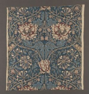  "Honeysuckle" by William Morris is a textile design featuring a symmetrical, mirrored pattern of honeysuckle flowers and leaves in deep blues, greens, and pale pinks on a linen fabric, displaying Morris's signature intricate botanical motifs with rich earthy colors.