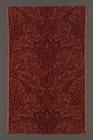  "Acanthus" by William Morris, a cotton velvet machine-woven textile featuring a symmetrical pattern of intricate Acanthus leaves in dark shades set against a warm, earth-toned background, symbolizing opulence and craftsmanship.