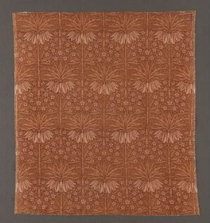  A monochromatic brown, machine-woven velvet cotton textile with a patterned design titled "Crown Imperial" by Lindsay P. Butterfield, featuring large, stylized floral motifs suggestive of imperial crowns interspersed with intricate, smaller botanical patterns, all in a deeper shade of brown than the twill base.