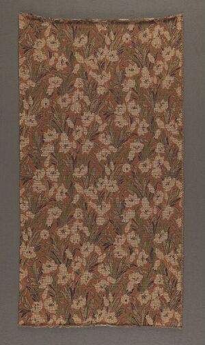  An antique-style fabric with a dense floral pattern in muted shades of pink, cream, and greens on a brownish-tan background.