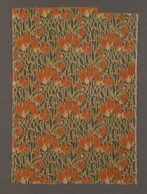  A detailed pattern of warm orange flowers and olive green foliage on a dark gray textile background, creating an ornate botanical design suggestive of a vintage piece, with no discernible artist name or title.