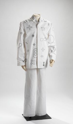  A sophisticated white coat and trousers set with subtle gray floral and abstract patterns, possibly embroidered, displayed against a neutral background.