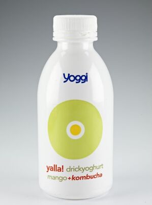  A plastic drinkable yogurt container by Lowe Brindfors Design with a white glossy background featuring a circular yellow to green gradient label and the name "Yoggi" in royal blue above the text "yalla! drickyoghurt mango + kombucha" in dark gray.