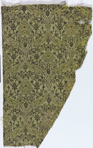  A fragment of olive green fabric featuring an intricate, darker green floral pattern with uneven and frayed edges, suggestive of historical tapestry work.