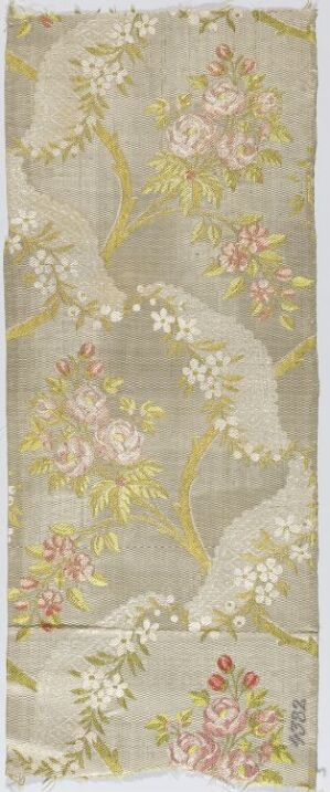  An elongated textile piece with a grey background featuring a golden vine pattern and clusters of pink, mauve, and white flowers with varied green leaves.