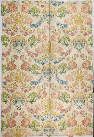  A floral-patterned fabric with a symmetrical design of flowers and foliage in pastel hues on a creamy beige background. The central fold line creates a mirrored effect on both sides.