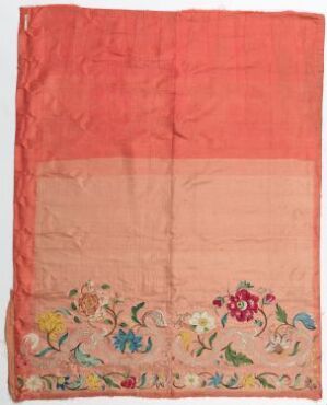  A rectangular textile piece with the top two-thirds in salmon-pink and the bottom one-third in pale pink, embellished with colorful embroidery or printing of flowers, birds, and insects in a garden scene.