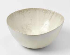  A lustrous silver bowl with a smooth exterior and a textured pattern of fine, linear marks on the interior, set against a neutral background.