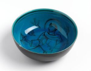  A round ceramic bowl with a vibrant blue glaze, featuring abstract and slightly lighter blue patterns and a figure-like design in the interior, set against a neutral background. Artist name and title are unknown.