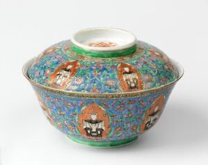  An elaborate Bencharong porcelain bowl with lid, displaying intricate overglaze enamel decorations of mythological figures and floral patterns in vibrant multi-colors against a jade green background. Artist unknown.