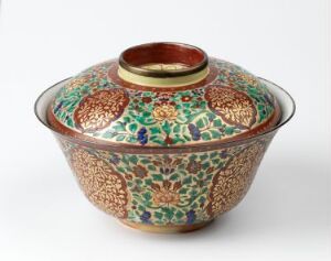  A traditional Thai Bencharong porcelain bowl with elaborate overglaze enamel decoration in red, green, and blue with brass edges, indicative of high craftsmanship and Asian design aesthetics, created by an unknown artist.