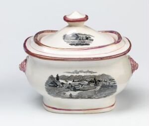  A small, antique porcelain tureen with a creamy white glaze featuring a detailed gray landscape scene on the body and muted rose accents along the rims and handles, topped with a matching lid that has a rose-tinted finial.