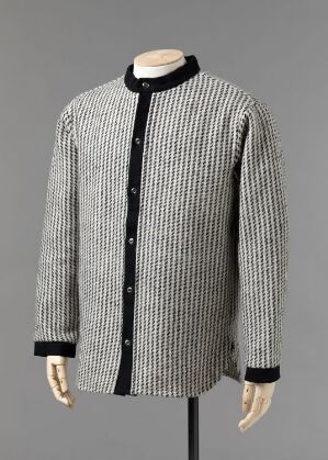  Handwoven long-sleeved men's shirt by Isabella Ihlen featuring fine vertical stripes in white and a dark color, with black trim on the flat collar and cuffs, and metallic buttons down the center.