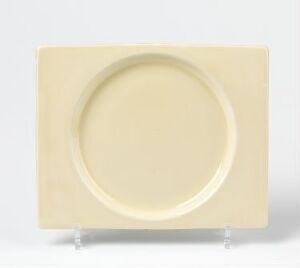  A square-shaped cream-beige glazed flintware dinner plate with rounded edges and a circular recess, designed by A.J. Wilkinson, positioned against a white background.