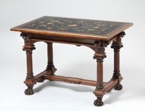  Antique-style table with claw feet and turned legs, featuring a dark tabletop with intricate floral marquetry in red, green, and yellow tones.