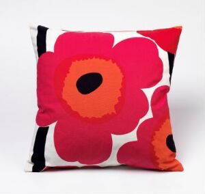  A decorative pillow designed by Maija Isola titled Unikko with a large pinkish-red and orange poppy pattern on a white background, edged with a black border.