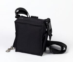  A black fabric utility bag by Luovi Productions Oy, titled "Luovi 003" with zipper and plastic buckles, exemplifying machine-woven cotton and synthetic materials with machine stitching, against a white background.