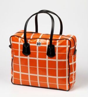  A structured handbag with an orange and white checkerboard pattern and black handles, featuring a black label with the number '10' in white text, set against a light grey background. Artistname and title of the piece are unknown.