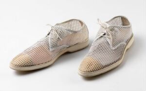  A pair of Helmut Lang's S/S 03 Homme Collection derby shoes with a semi-transparent micro sole mesh upper, featuring a color gradient from off-white at the toe to light tan at the heel, with cotton laces and leather accents.