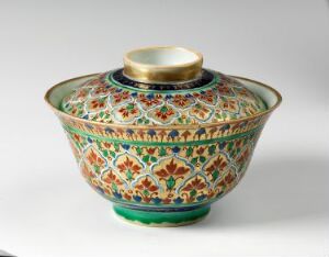  An exquisite Bencharong porcelain bowl with a lid, featuring rich emerald green, blue, yellow, and red enamels with gold highlights, on a white background. The design boasts intricate floral and geometric patterns, indicative of traditional Thai ceramics. Artist unknown.