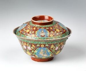  A traditional Bencharong porcelain bowl with a lid, featuring intricate multi-colored overglaze enamel decoration, including a central medallion with a figure scene, on a dark blue background with floral and geometric patterns in red, yellow, green, and white.