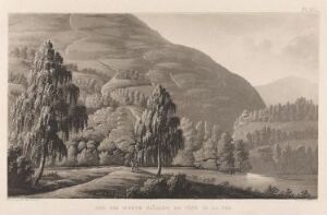  "Ved foten av fjellene" by Martin Rudolf Heland is a sepia-toned etching depicting a tranquil landscape with pine trees in the foreground beside a still body of water, with gently rolling mountains in the background under a softly shaded sky.