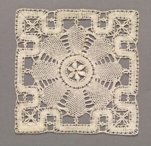  An intricately crafted square lace doily with a central eight-pointed star design and symmetrical floral patterning set against a solid mid-tone gray background.