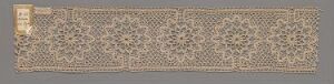  An elongated horizontal textile piece with a beige background featuring a complex, dark brown repeating geometric floral pattern, indicative of traditional Middle Eastern or Islamic art influences.