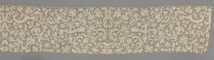  A long, horizontally oriented decorative textile or wallpaper strip featuring an intricate symmetrical floral and foliage pattern in muted cream, beige, and taupe colors. Artist name and title are unknown.