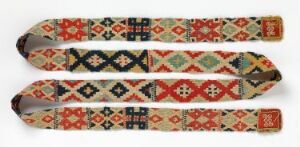  Two traditional woven textile bands with intricate geometric patterns in red, orange, dark blue, black, and green on an off-white base.