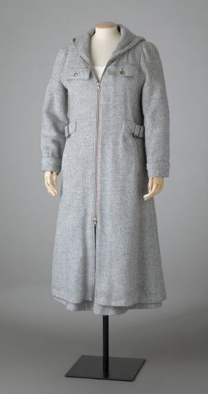  A long, light-to-medium gray colored coat with a hood and high collar on a mannequin against a neutral background.