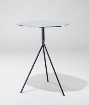  A modern table, "Stone," designed by Ilkka Suppanen, featuring a light-colored hexagonal top made of formbent and powder-coated HPL on a tripod base of intersecting powder-coated steel legs, set against a white background.