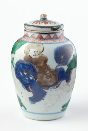  A traditional glazed ceramic vase with a lid, showcasing deep blue and emerald green floral patterns on a pale cream background, accented by geometric designs around the neck and lid.