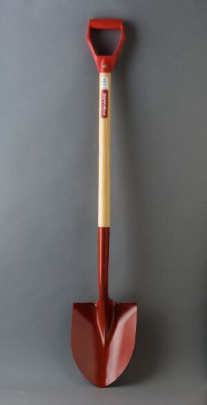  A red and wooden-colored shovel with a long handle and a pointed spade, displayed against a neutral gray background.