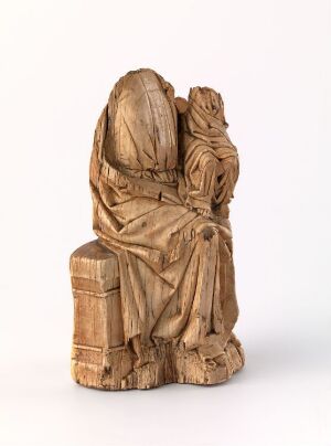  A small wooden sculpture depicting two figures in an intimate embrace with intricate carvings that suggest flowing garments, rendered in light brown tones with visible wood grain. Artist's name and title are unknown.