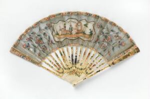  An antique, partially opened hand-held folding fan with a painted pastoral scene including small human figures, framed by elaborate floral motifs and gilded accents on the sticks.