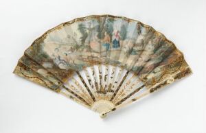  An antique handheld fan with a delicate, painted scene featuring figures and pastoral motifs, set against a plain white background. The fan has a series of narrow ribs converging at the base, with colors primarily in muted earth tones and a sense of historical elegance.