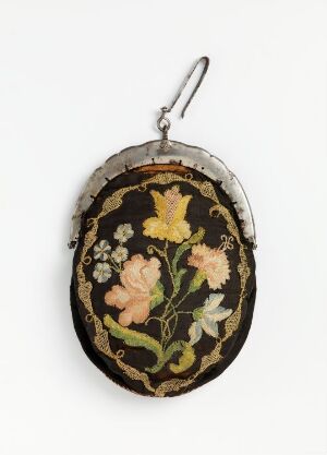  An antique-style, oval-shaped purse with a metallic frame and clasp, featuring a prominently displayed floral embroidery in golden yellow, peach, and pink tones against a black background with green foliage patterns.