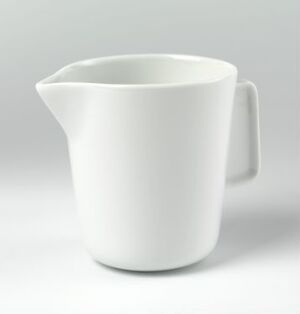  A modern and minimalist white porcelain jug, designed by Norway Says, featuring a glossy surface, a curved spout, and an angular handle, set against a subdued background. The jug demonstrates a sleek and functional Scandinavian design.