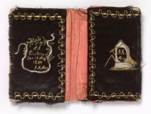  An open antique book with a dark velvet cover, detailed with gold embroidery, featuring the letters "E Σ E" and the date "1896" on one side and an emblem with an hourglass on a book and an anchor on the other side, with a faded pink spine.